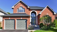 a brick home with a garage and driveway