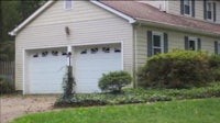 a house with two garage doors in front of it
